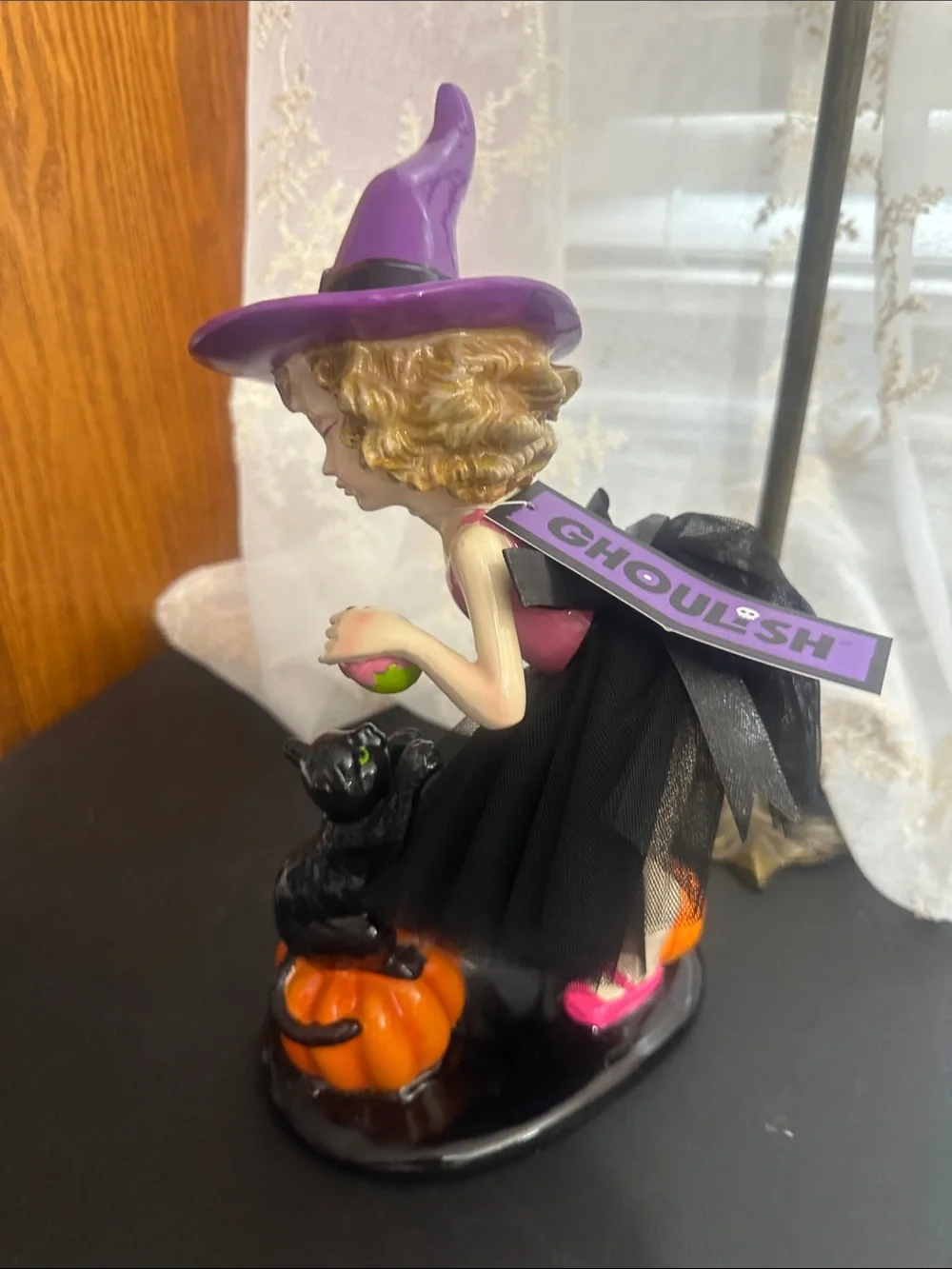 Ghoulish Halloween little girl with black cat decor